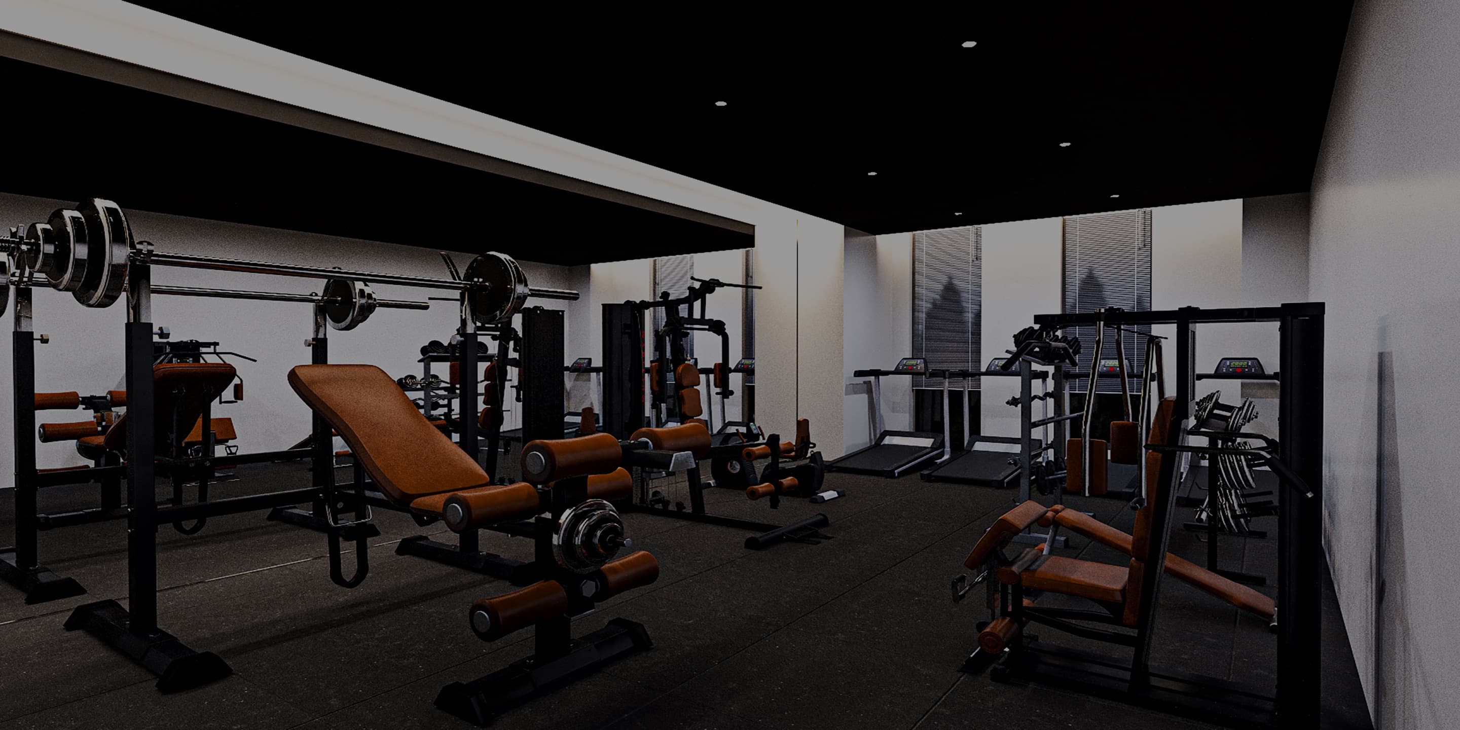 Spacious commercial gym with strength benches and racks