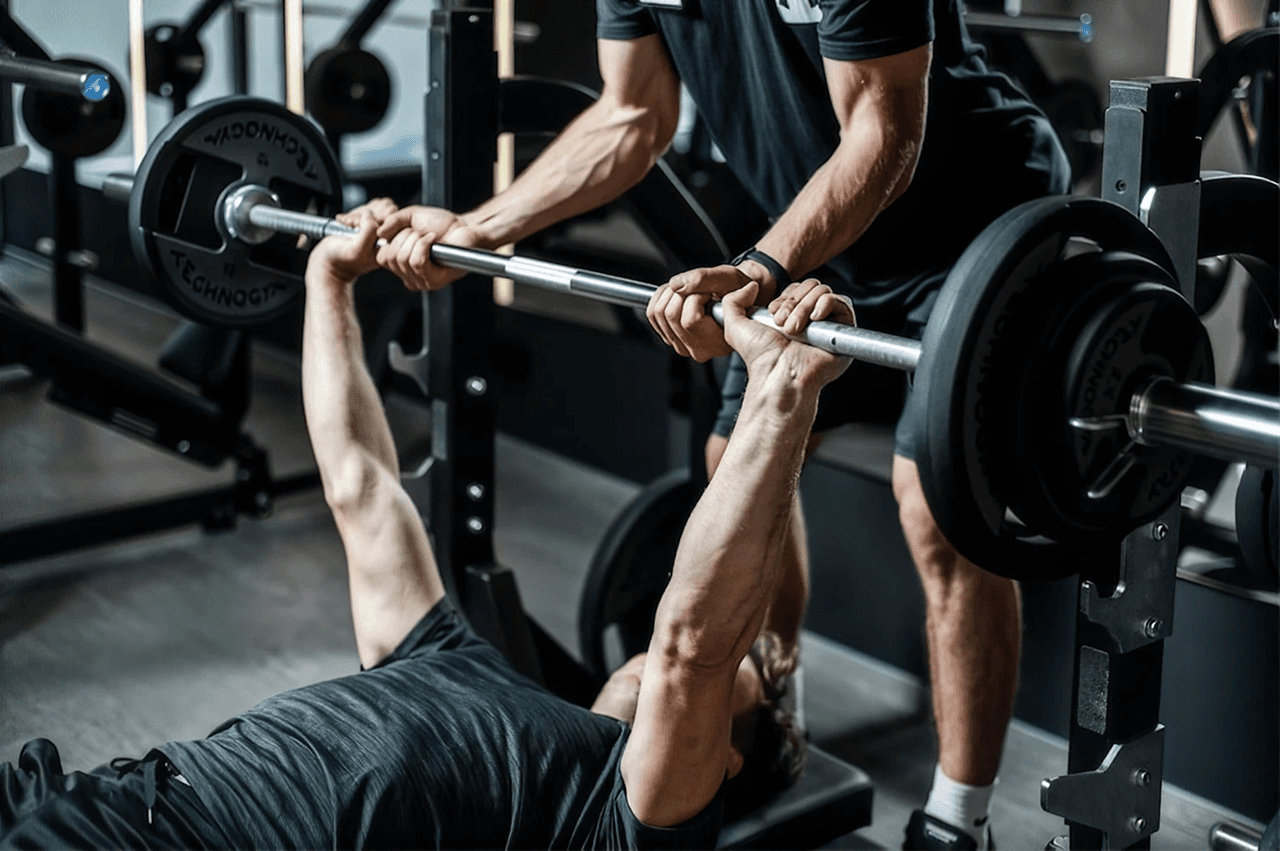 Athlete bench pressing a heavily loaded barbell