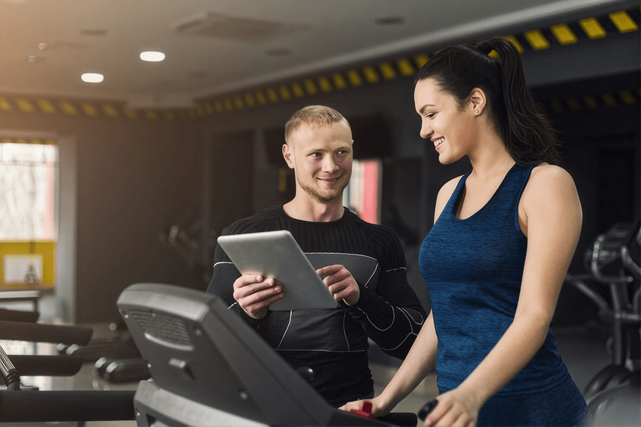 A coach helping a member during a gym session